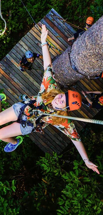 Zipline rider high in the jungle canopy on Koh Samui